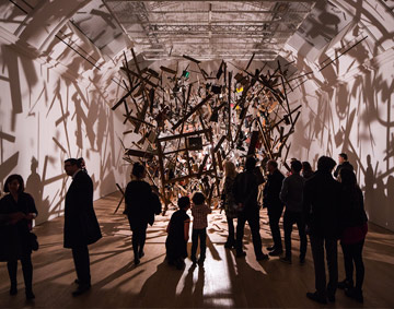 People in Cornelia Parker exhibition at the Whitworth, the installation of a shed frozen in midexplosion
