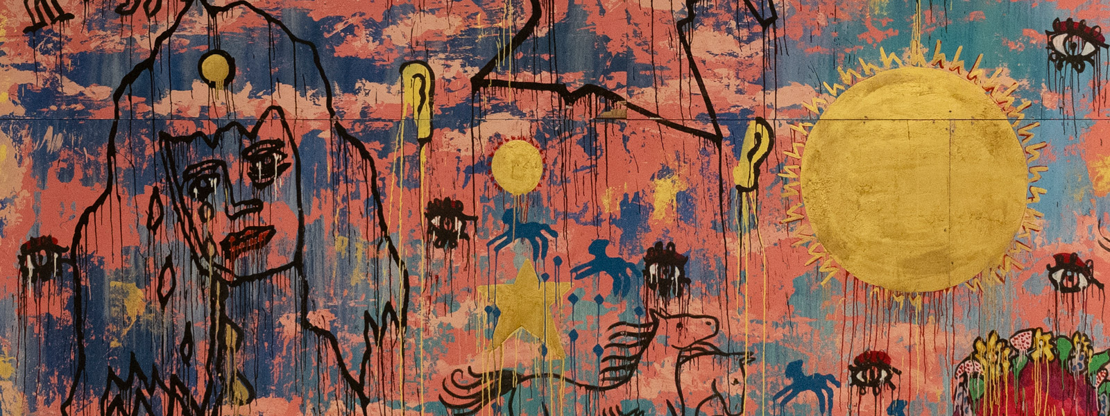 a colourful artwork showing various figures and a golden sun emblem