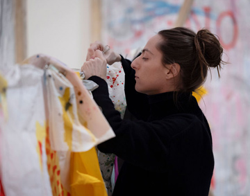 a person looking through fabric on a rail