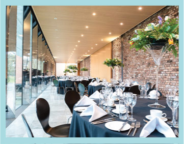 tables set for dining in a promenade with windows on the left side