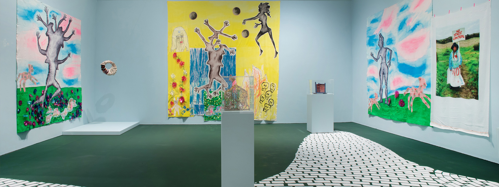 a colourful artwork showing various figures and a golden sun emblem