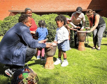 A group of families playing on drums