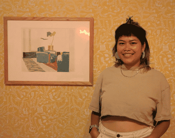 Penny stood in front of the Recoverist Curator exhibition