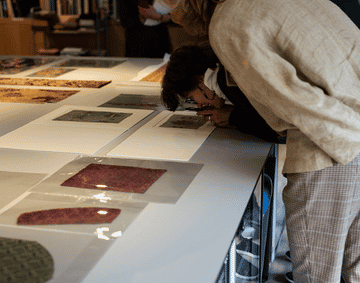 A group of people looking at textile samples inside the Study Centre