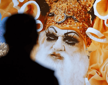 video still of drag queen and shadow figure