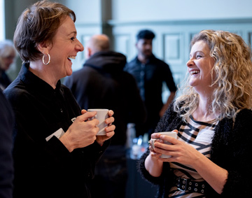 two people laughing in a conversation