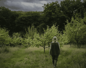 A person standing in a green field