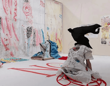 A performer inside Delaine Le Bas: Un-Fair-Ground