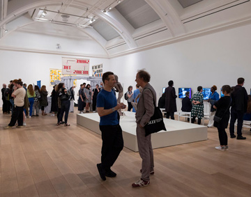 people gathered in a gallery space
