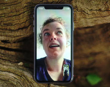 Rosalie Schweiker on an iphone screen, the iphone is resting on a wooden background
